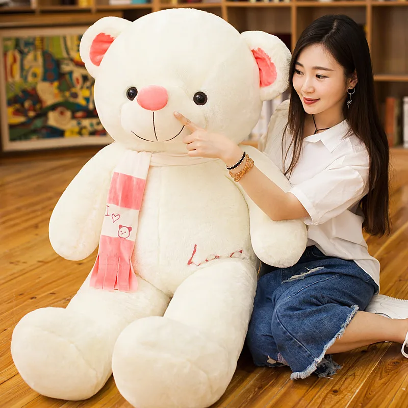 girl hugging big teddy bear