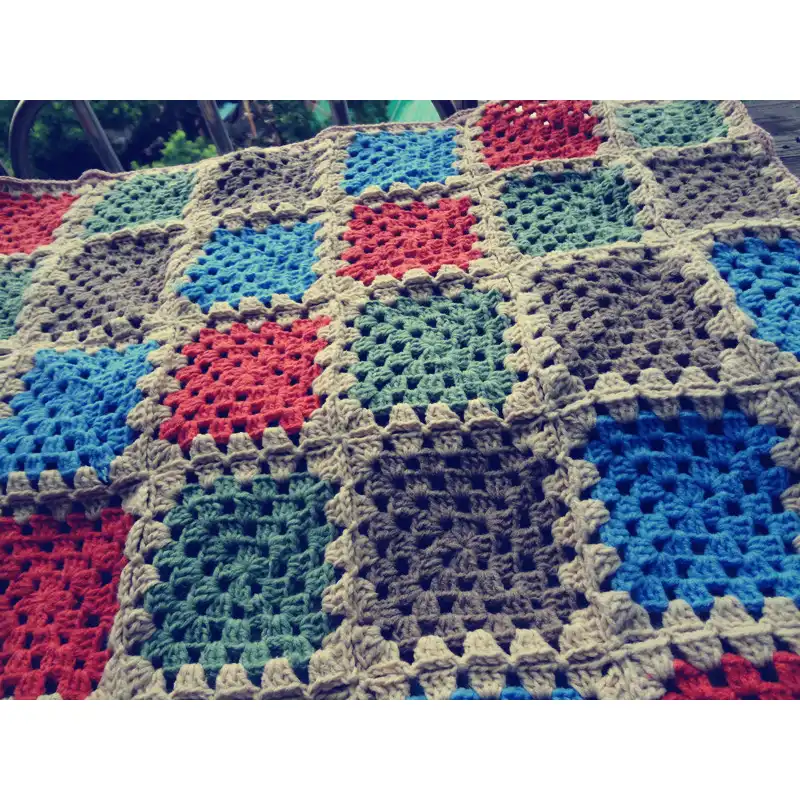 Handmade multi coloured patchwork crocheted baby blanket