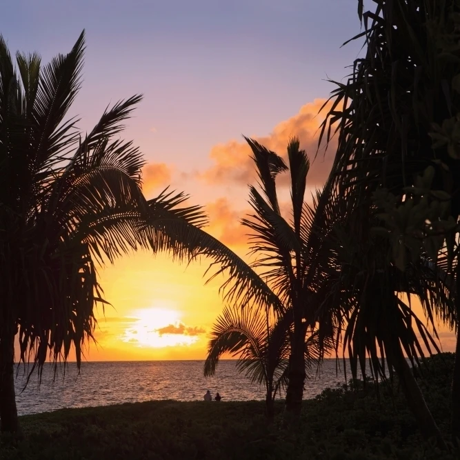Hawaii  Oahu  Kailua  Lanikai  Vibrant sunset with a couple on beach. Poster Print (19 x 12)