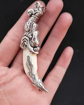 

China Tibetan silver carving dragon head dog tooth amulet pendant