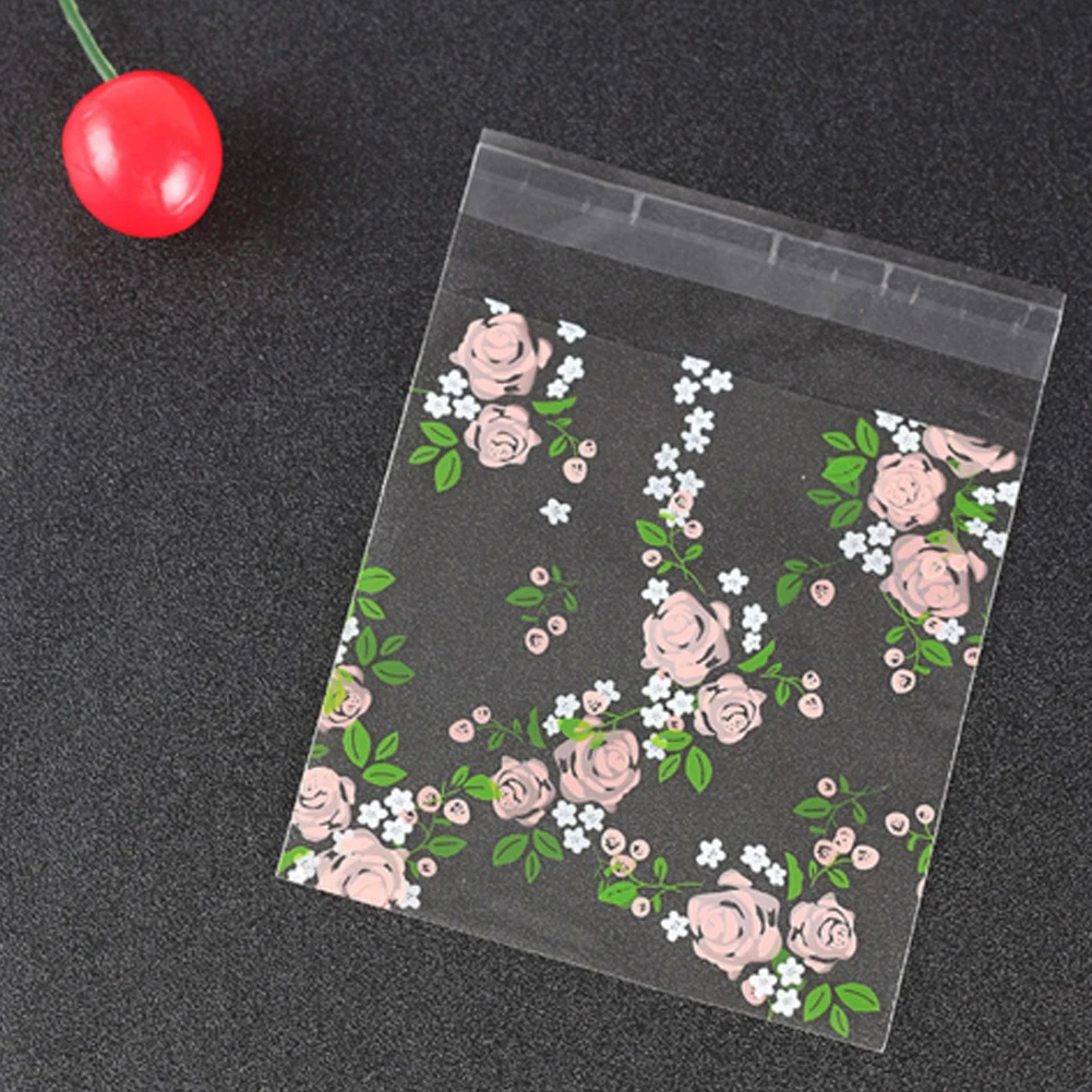 

100pcs Plastic Transparent Cellophane Rose Pattern Candy Cookie Gift Bag with DIY Self Adhesive Pouch Wedding Birthday Party
