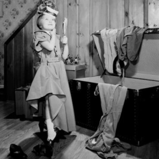 Girl trying on mother's clothes Poster Print (18 x 24)
