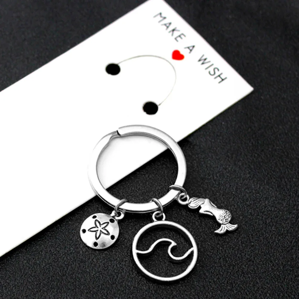 

Ocean Waves Mermaid Sand Dollar Keychain Starfish Shell Sea Turtle Seahorse Infinity Keychains Key Chain Key Ring Jewelry Gift
