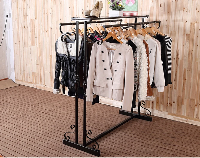 wrought iron clothes rack. Floor type clothing store shelves.