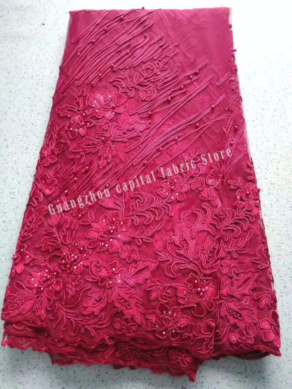

The latest design is an antique embroidery lace fabric with delicate beads for a party dress