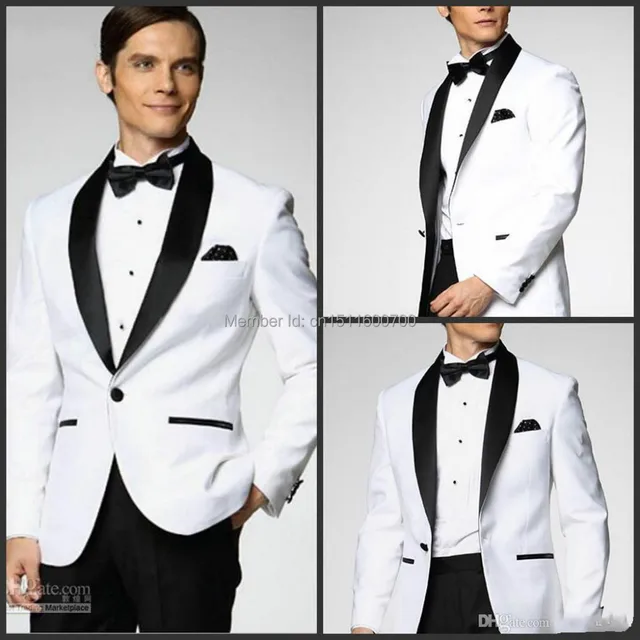 White coat and black satin lapels dress the groom, holds the best man