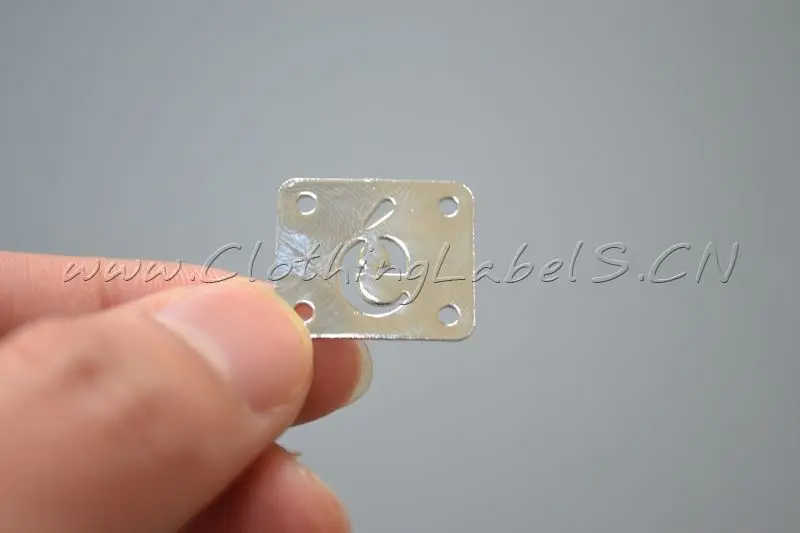 

custom metal labels for bags, clothing, shoes etc., in copper, hollow engraved logo in shape