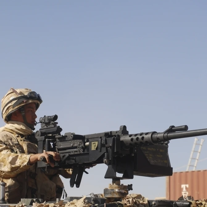 A Royal Marine manning a .50 caliber machine gun Poster Print (34 x 22)