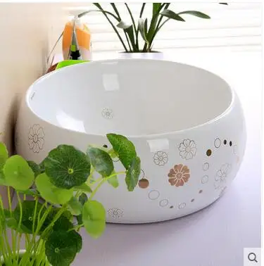 

On the ceramic bowl round art basin sink golden coloured drawing or pattern simple european-style bathroom sinks