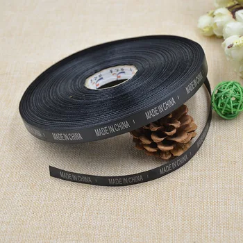 

A black ribbon printing silver word Chinese manufacturing origin mark to OEM.