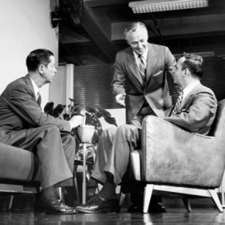 Low angle view of three businessmen talking Poster Print (18 x 24)