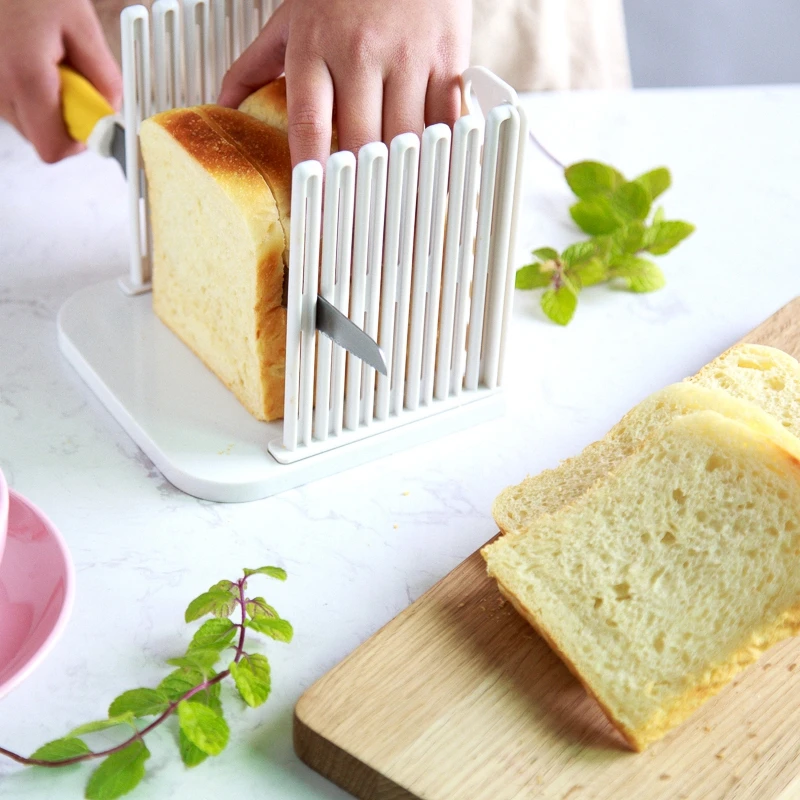 https://ae01.alicdn.com/kf/HTB1z_ltaNz1gK0jSZSgq6yvwpXad/Plastic-Foldable-And-Adjustable-Bread-Slicer-Plastic-Splicing-Toast-Loaf-Cutter-Rack-Slicing-Kitchen-Baking-Accessories.jpg