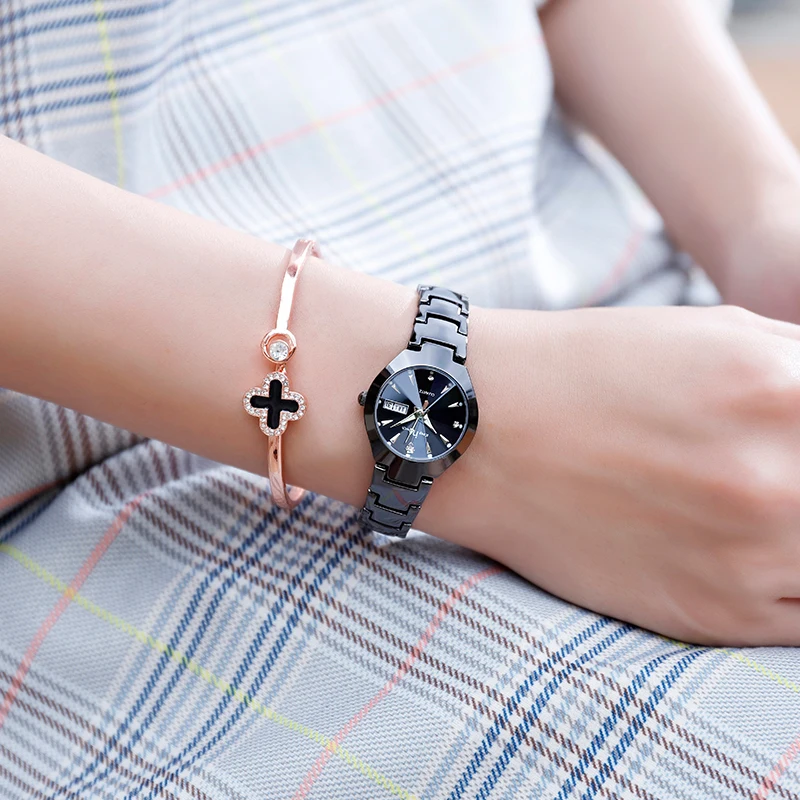 A woman sporting a stylish Small Dial Ladies Fashion Watch with a small dial on her wrist, complemented by a bracelet.
