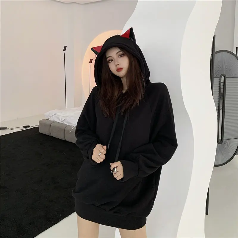 a japanese model wearing a harajuku style cat hoodie with ears that looks kawaii