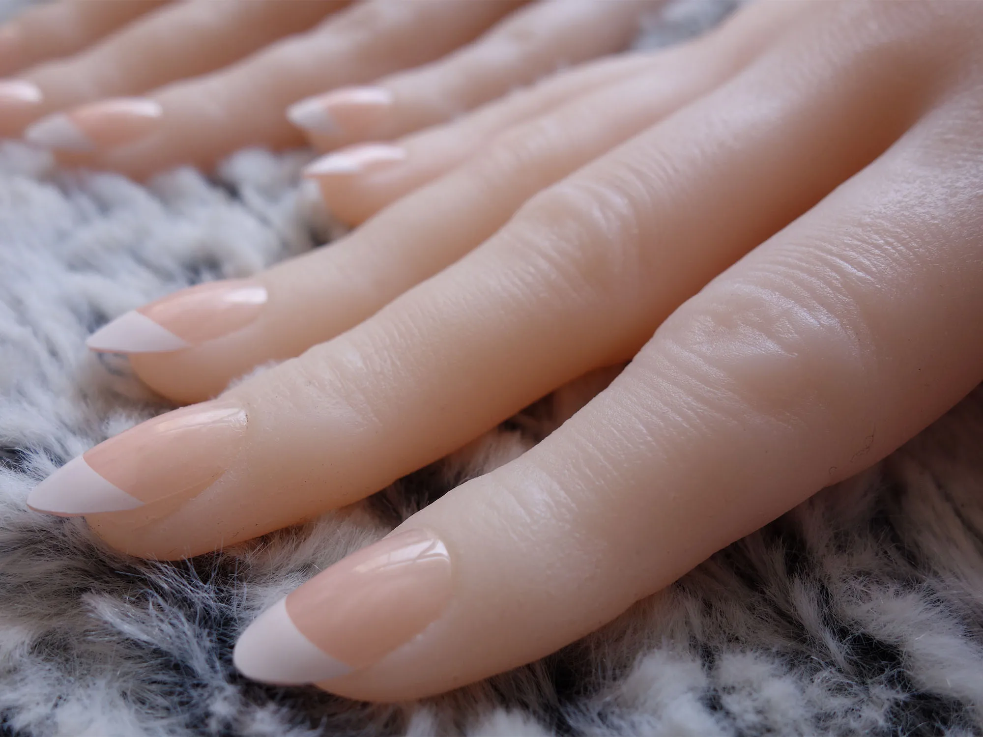 mannequin hand with perfect manicure and pink nail polish. Stock Photo