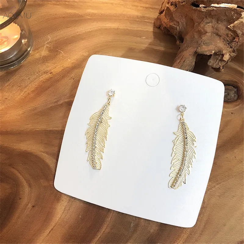 

AOMU New Korean Metal Gold Hollow Curved Feather Crystal Rhinestone Drop Earrings for Women Birthday Gifts Party Jewelry