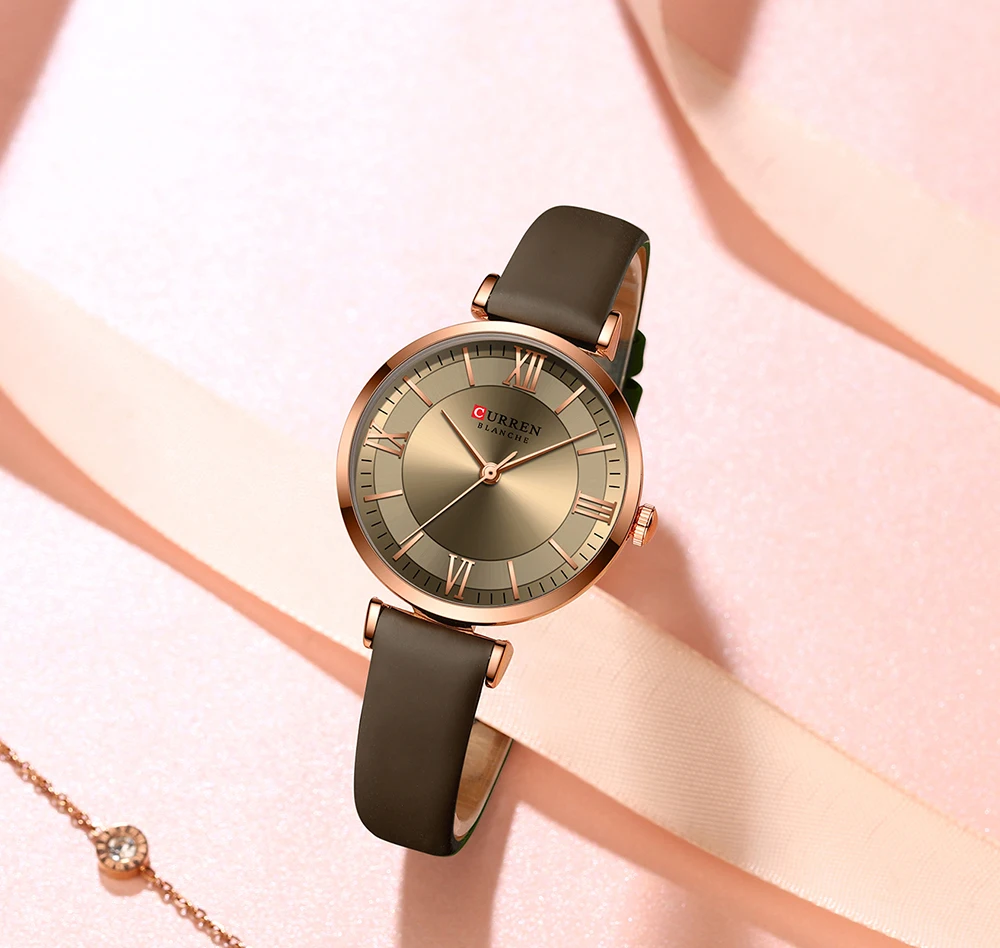 A Classic Clock Leather Wristwatch Multiple Colors on a pink background.