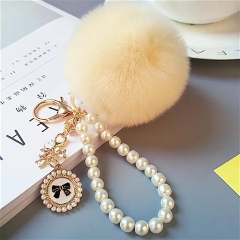 2023 Fashion Pearl Chain Crystal Bottle Bow Pompon Portachiavi Car Women Handbag Portachiavi Ring Fluffy Puff Ball Portachiavi Gioielli