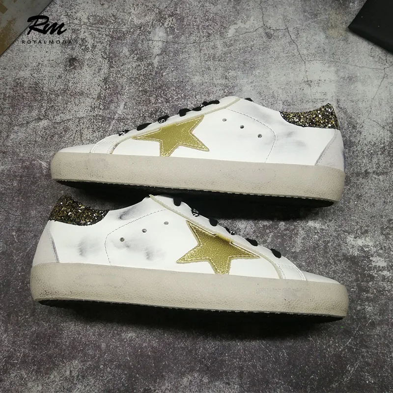 white sneakers with gold stars