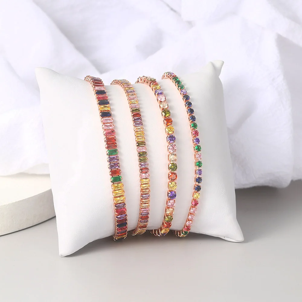 A set of Rainbow Zircon Chain Tennis Bracelets for Women on a stylish pillow.