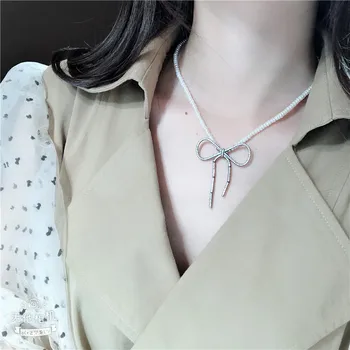

Hand knotted 5-6mm white bread freshwater cultured pearl micro inlay zircon bowknot accessories pendant sweater necklace long 45cm