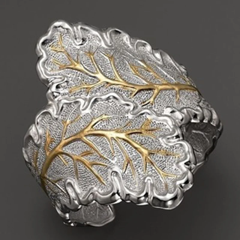 

Fashion lady personality creative design ring gold color with silver color leaves can control the size of the opening ringR4M110