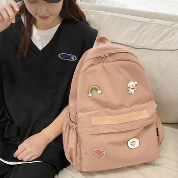 

DCIMOR New Waterproof Nylon Women Backpack Female Solid Color School Bag for Teenage Girls Travel bag Cartoon badge Book Mochila