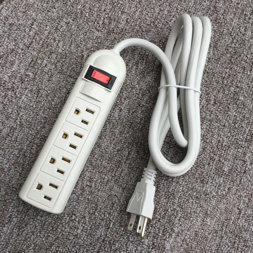 A white power strip sitting on top of a carpet
