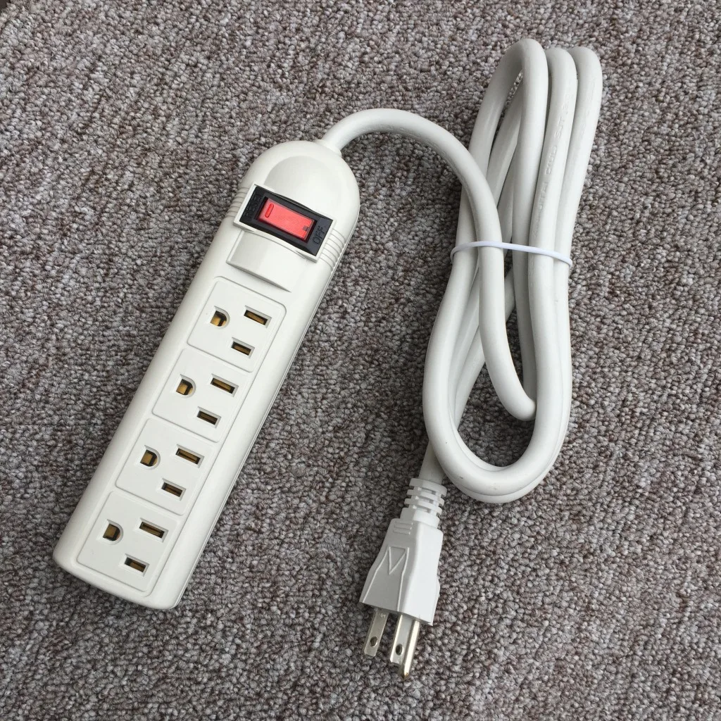 A white power strip sitting on top of a carpet