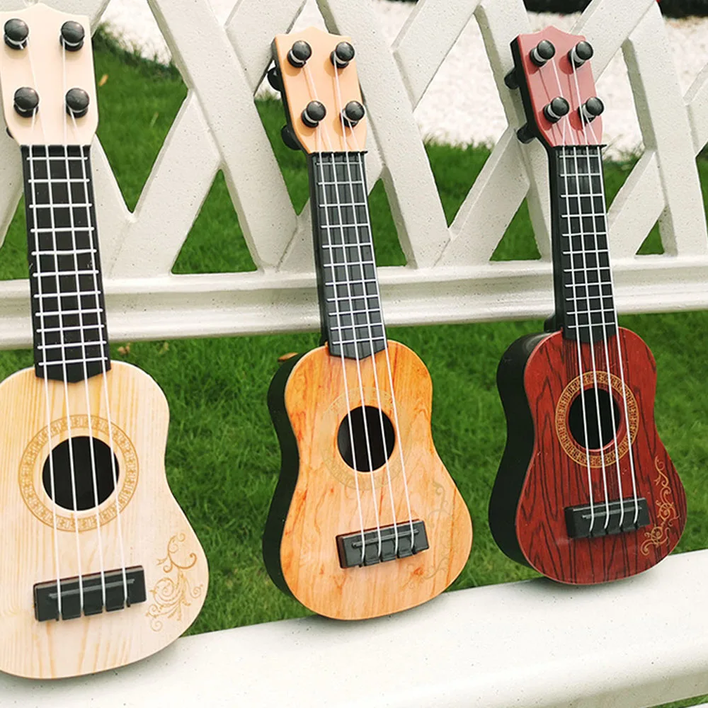 Éveil de musique Petit modèle Instrument de musique Instrument de musique Mini ukulélé pour enfants Jouets éducatifs pour enfants Guitare à 4 cordes Mini guitare