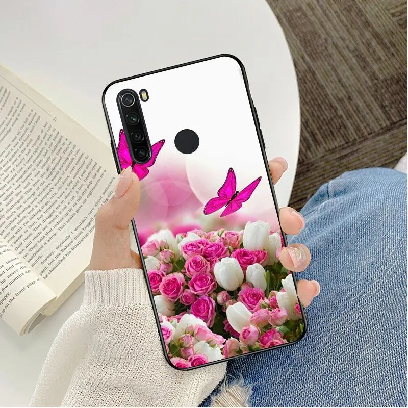 Red butterfly on white roses flower