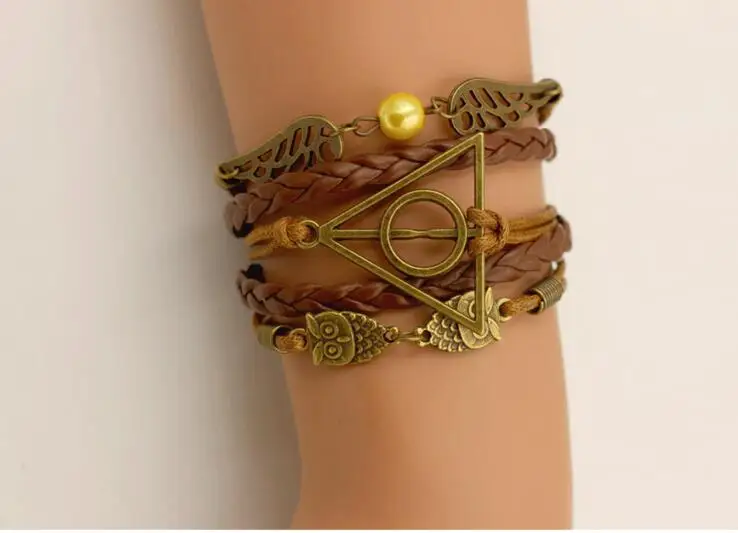 

HOT Harri Potter Death Hallows Retro Leather Cord Bracelet Golden Wings Flying Thief Triangle Action Figure Multilayer Bracelet