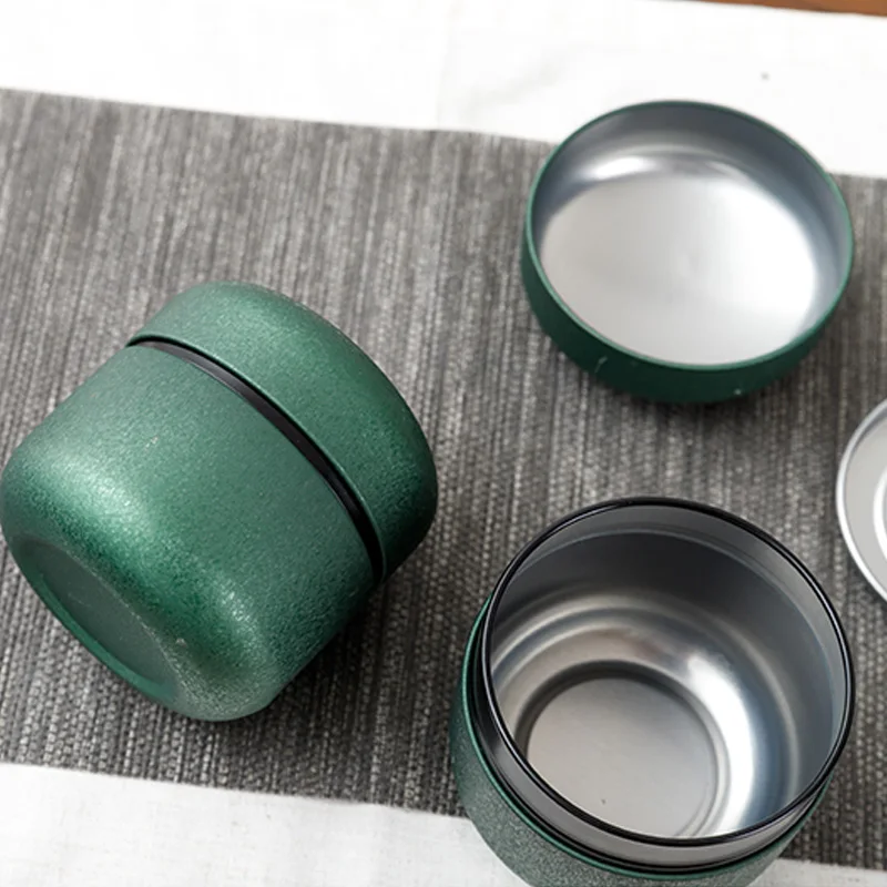 

Xin Jia Yi Packaging Matte Black Printed Round Tea Tins Deep Lid Round Tea Tins Metal Tin Box