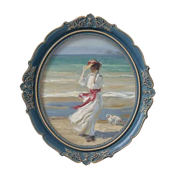 Woman on the beach painting with blue embossed oval frame