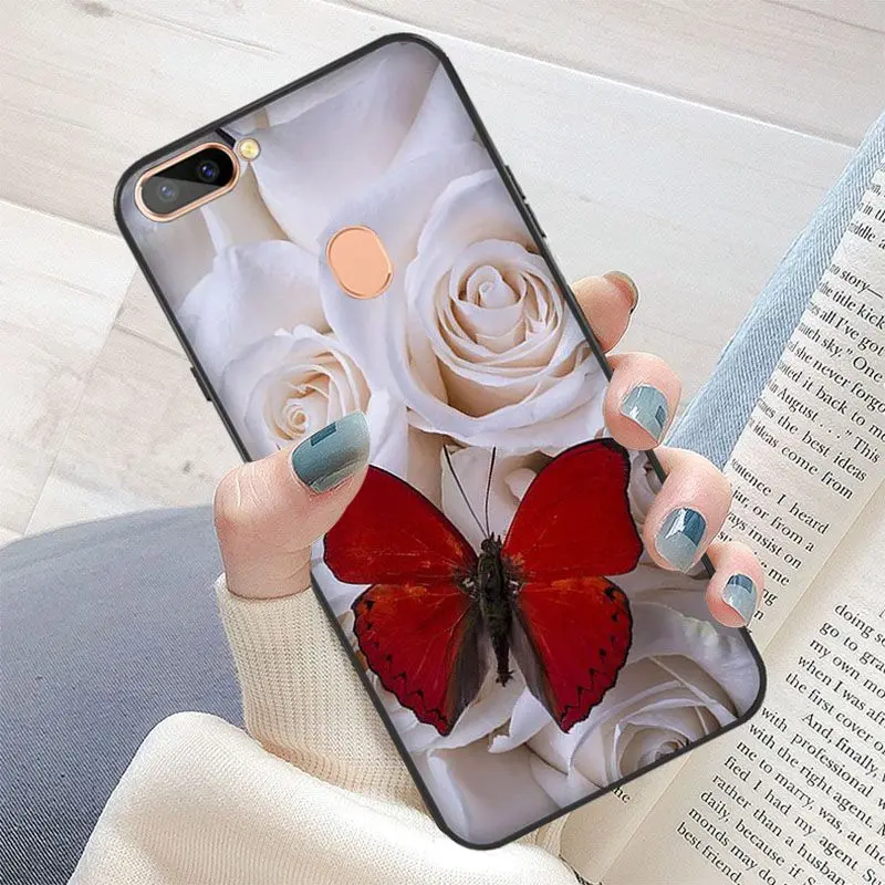 Red butterfly on white roses flower