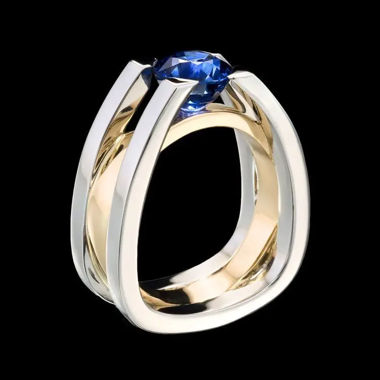 

Two-tone women's wedding/engagement ring inlaid with blue artificial gemstones and simulation diamonds