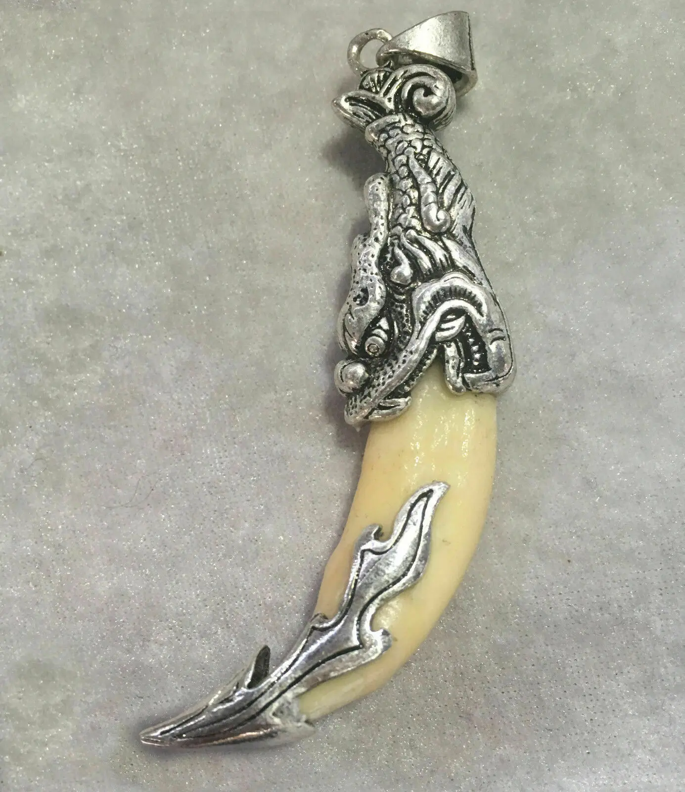 

Wolf's teeth pendant set with Tibetan silver charms pendant