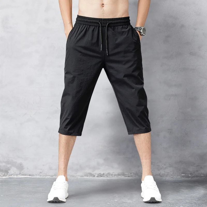 Tanie Letnie męskie spodnie cienkie nylonowe przycięte spodnie solidne czarne bryczesy