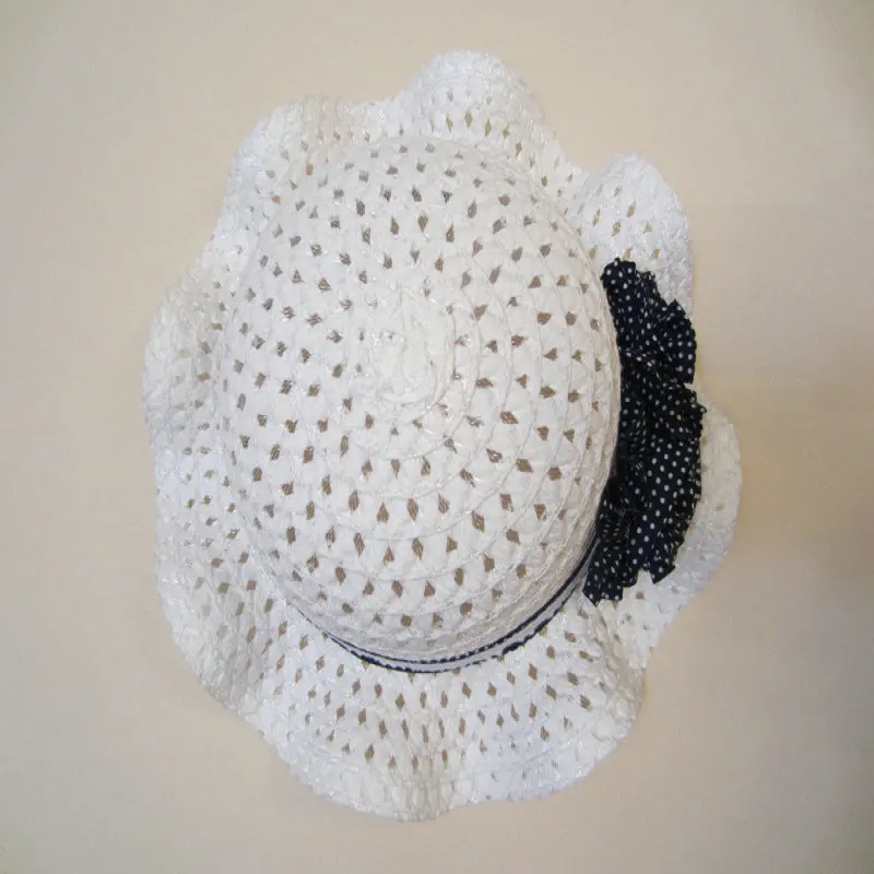 Empty dark blue polka dot flowers on white children's straw hat children's sun hat spring summer hat