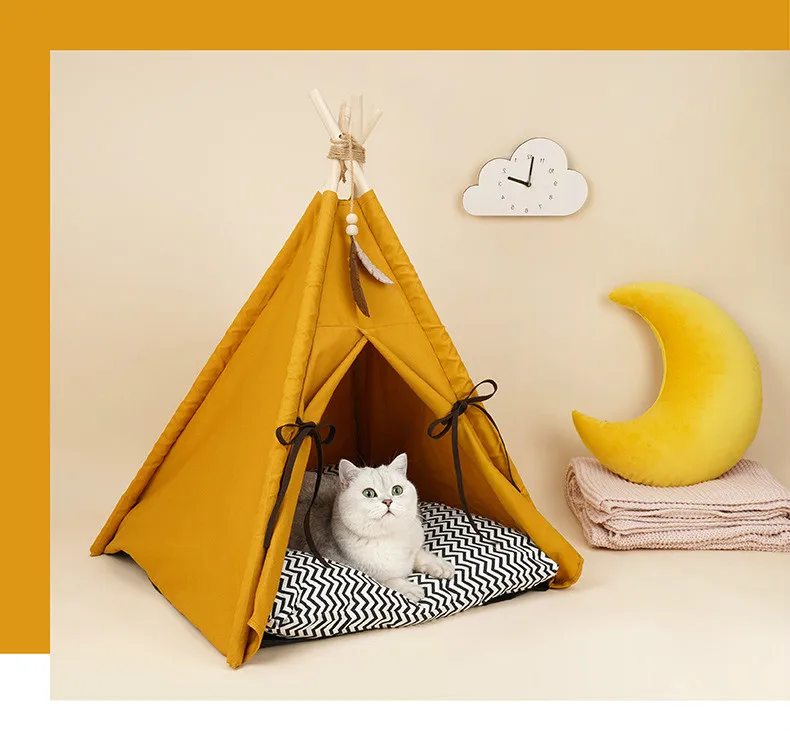 a cat lying inside a yellow cat tent with a luxurious appearance