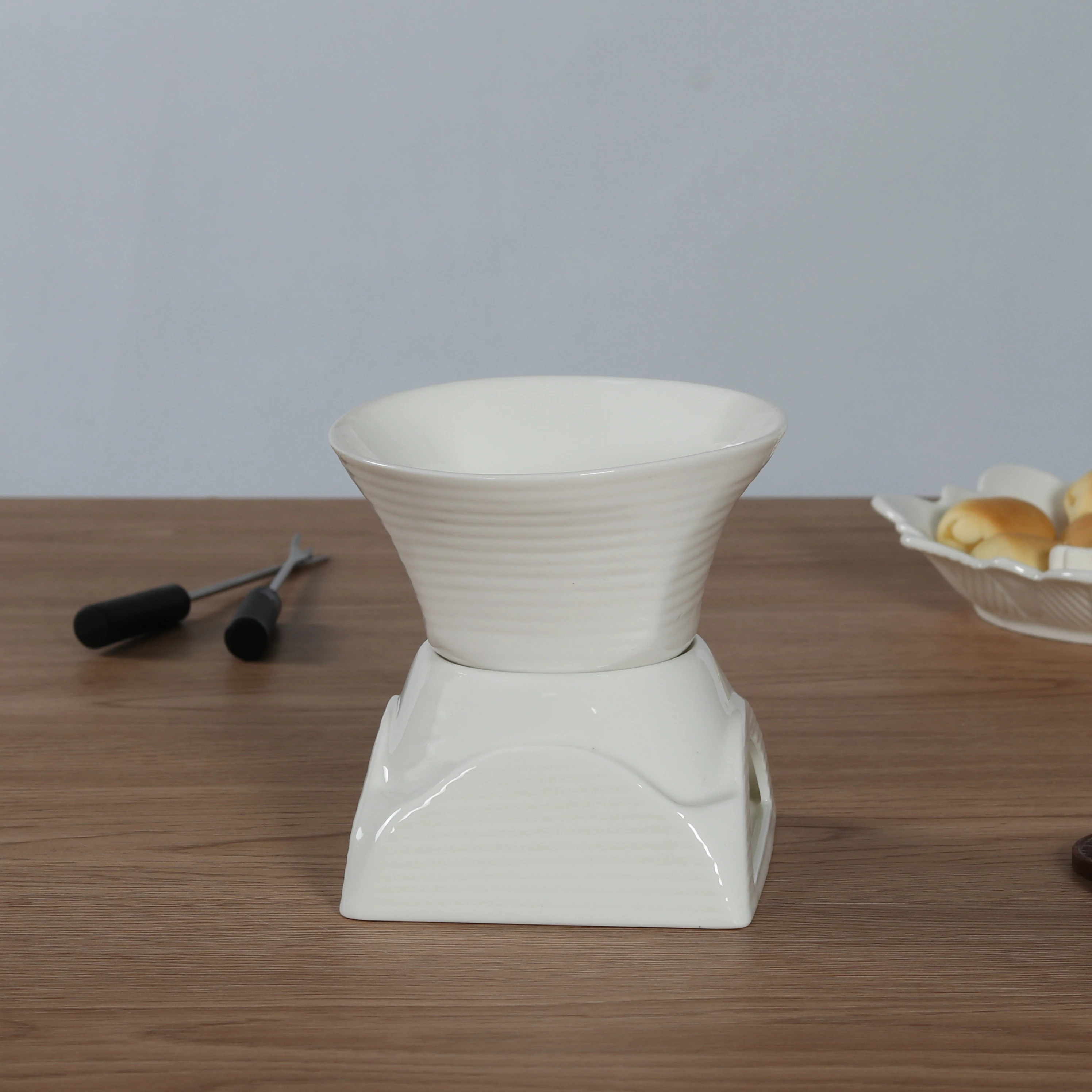 White ceramic fondue pot for chocolate and cheese melting
