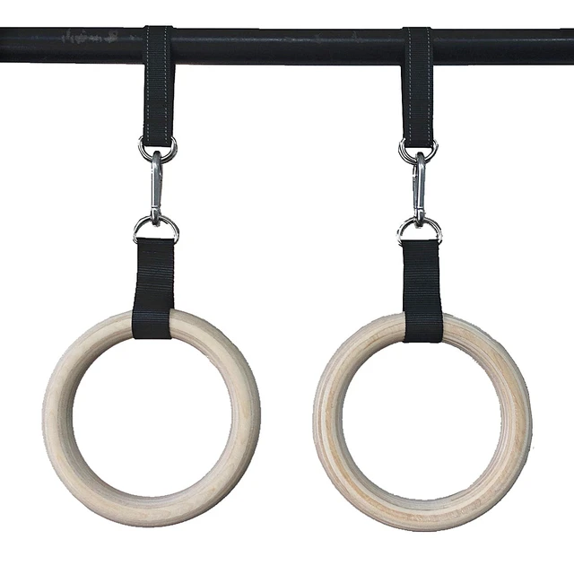 Gymnastic rings hanging against wall at health club stock photo