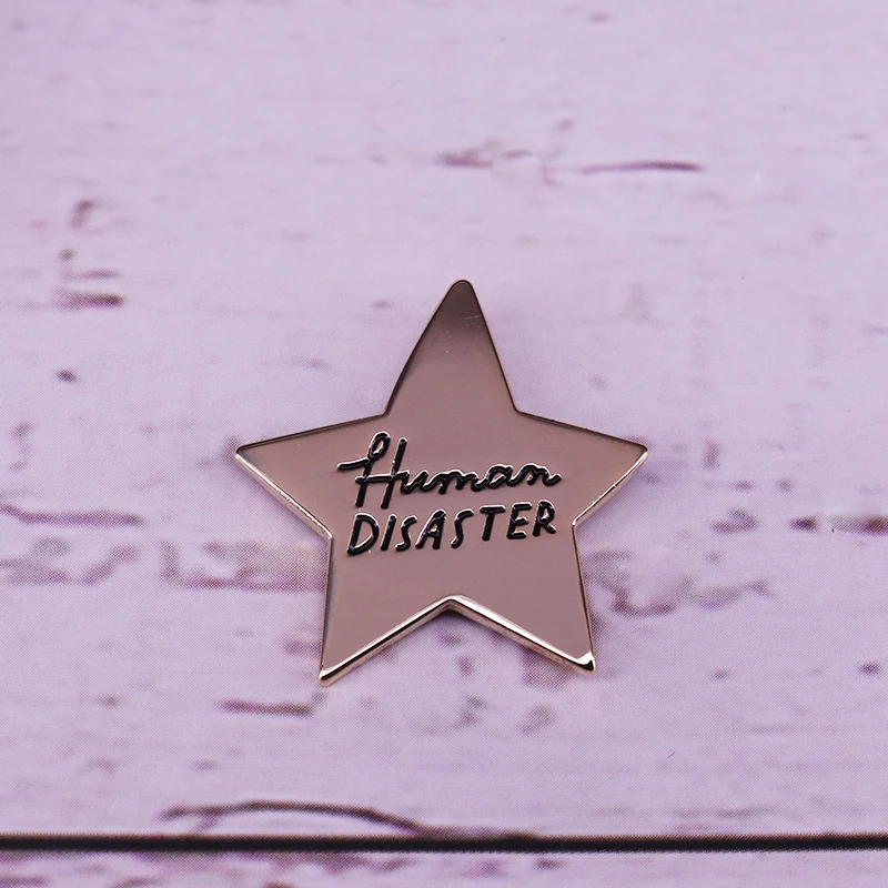 

Human Disaster gold star enamel pin