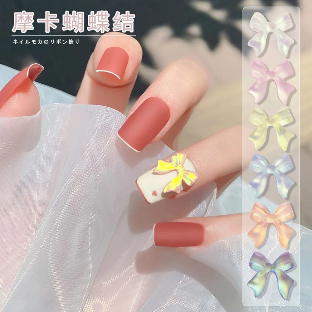

50Pcs/Bag Aurora Ribbon Bownot Nail Art Decorations 11*11mm 3D AB Resin Mocha Charms Korean Flatback Manicure Accessories QE-671