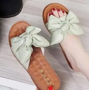 

Korean version of non-slip flat bottom cool slippers women summer fashion bowknot wearing joker beach slippers