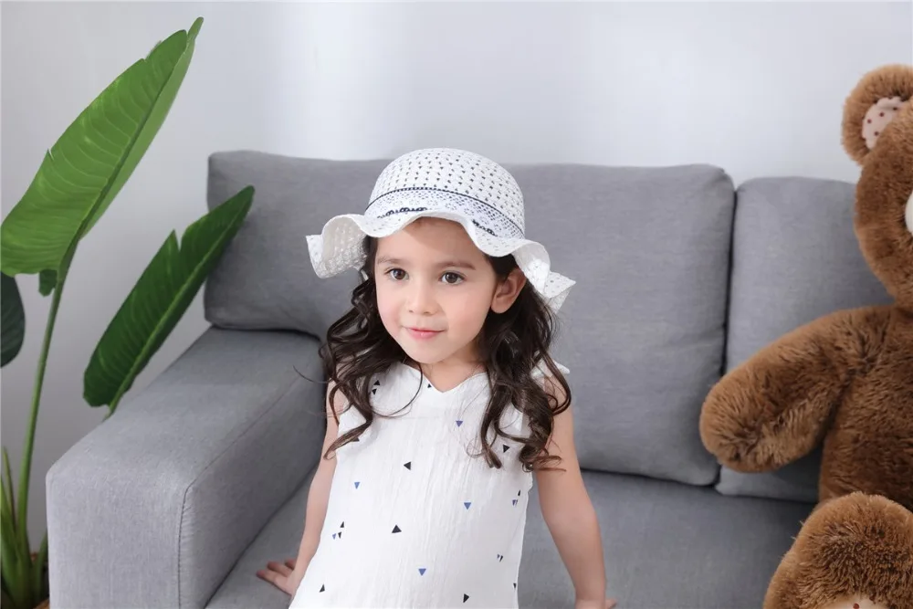 Empty dark blue polka dot flowers on white children's straw hat children's sun hat spring summer hat