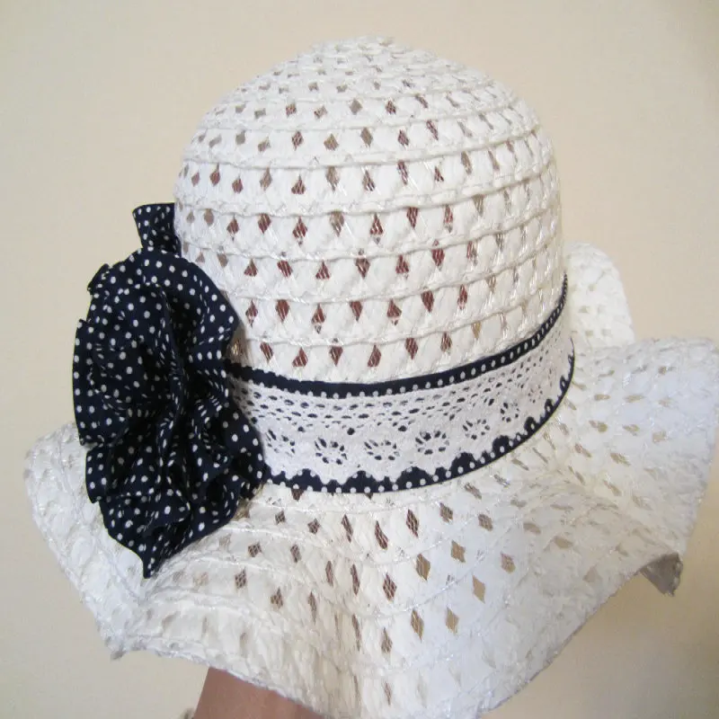Empty dark blue polka dot flowers on white children's straw hat children's sun hat spring summer hat