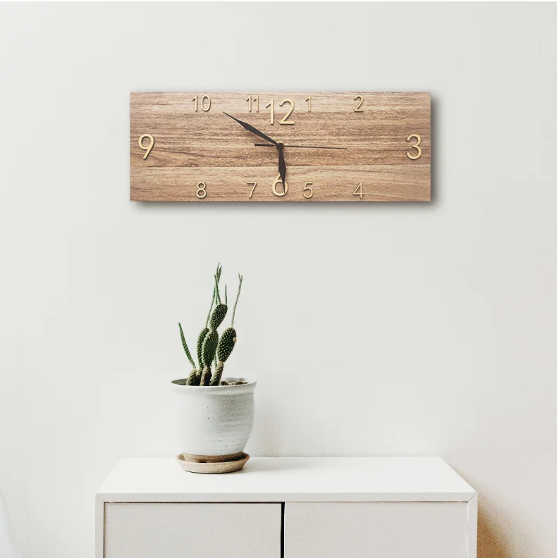 A modern rectangle wall clock above a flat-screen television in a room with a marble wall adds an elegant accessory to the space.