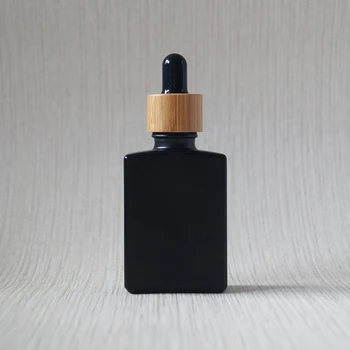

Custom wholesale 30ml 50ml 100ml food grade black frosted square rectangle essential oil glass dropper bottle with bamboo cap