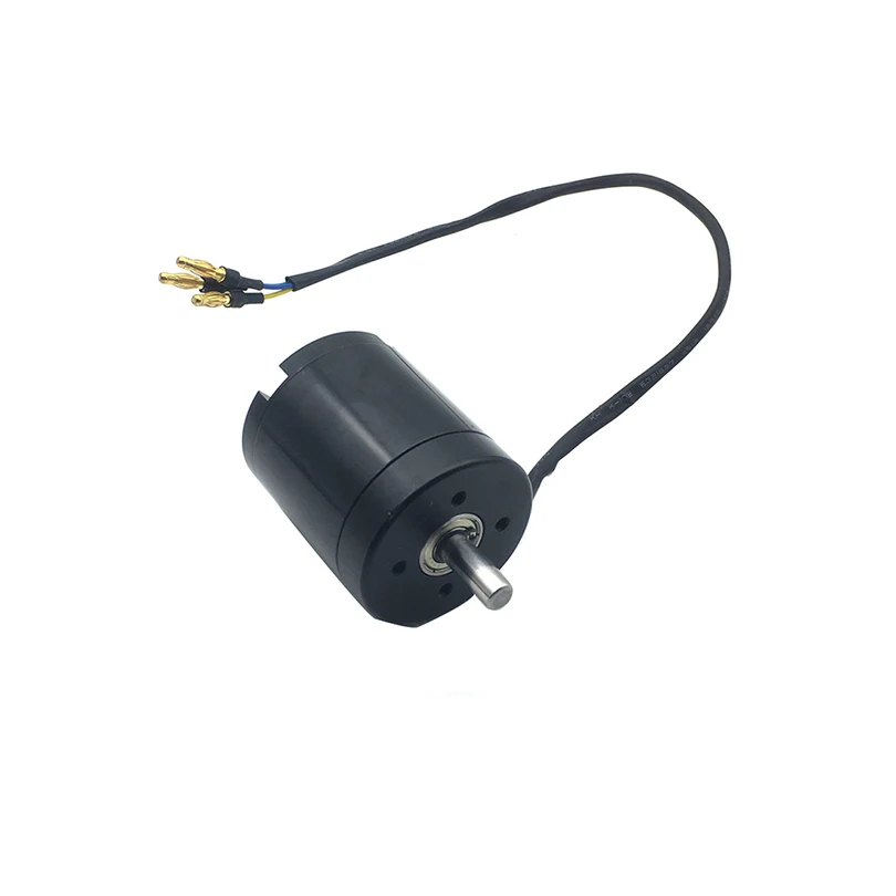 Moteur Brushless 5065 140KV pour drone RC, comparé à une pièce de monnaie pour l'échelle, finition métallique.